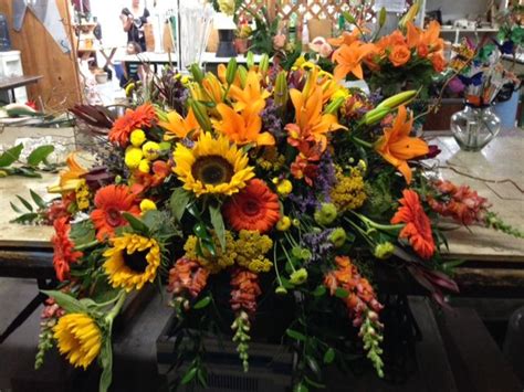 A few good options might include blue hydrangeas or cornflowers. Half casket spray of fall colors ~ Padaro Floral | Funeral ...