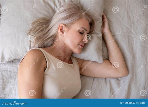 Peaceful Healthy Mature Woman Lying Asleep In Bed Top View Stock Image