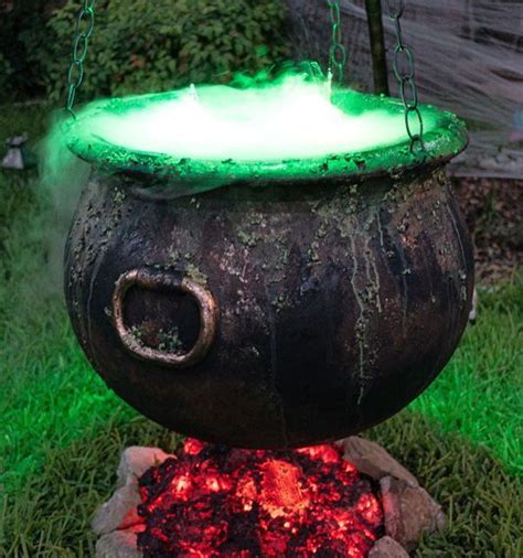An Old Caulder With Glowing Green Lights In The Grass Next To A Fire Pit