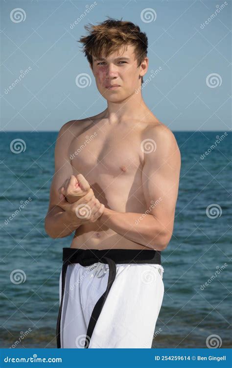 A Shirtless 17 Year Old Teenage Boy Flexing His Muscles Stock Photo