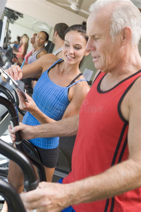 Personal Trainer Instructing Man On Treadmill Stock Image Image Of
