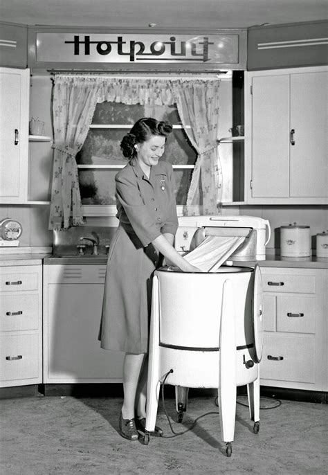A Woman Demonstrates A Hotpoint Wringer Washing Machine
