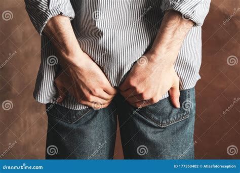 Man In Jeans Holds His On Background Hemorrhoids Stock Photo Image Of Jeans Adult