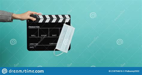 Hands With Grey Suit And Hold Black Clapper Board Or Movie Slate With