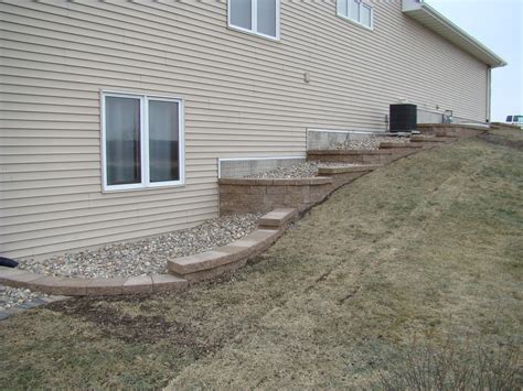 A House With Stone Steps Leading Up To The Front Door And Side Yard Area