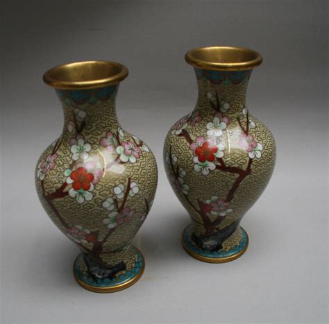 A Pair Of Chinese Cloisonne Vases With A Pale Green Background