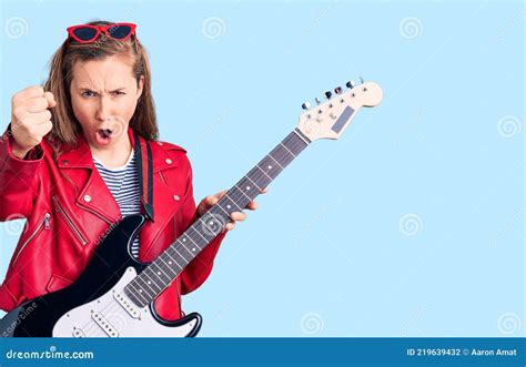 Young Beautiful Blonde Woman Playing Electric Guitar Annoyed And