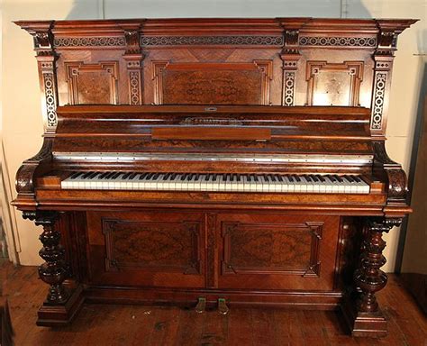 An Antique Glass Upright Piano With An Ornate Walnut Case And Carved