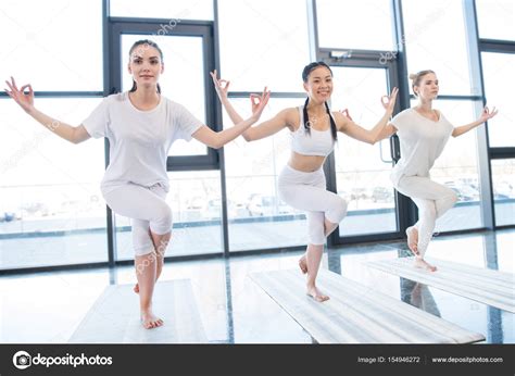 Young Women Practicing Yoga — Stock Photo © Dmitrypoch 154946272