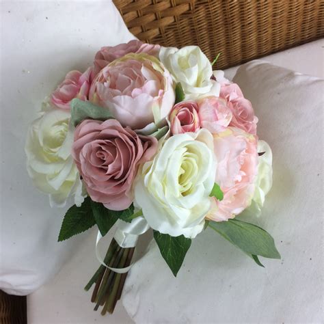 A Brides Bouquet Of Pale Pink And Ivory Silk Roses And Peony Flowers