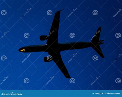 Silhouette Of A Landing Aircraft At Sunset Stock Image Image Of