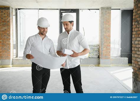 Two Young Man Architect On A Building Construction Site Stock Image