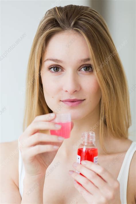 woman using mouthwash stock image c034 0816 science photo library