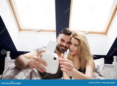 Couple Taking Selfie With Instant Camera At Home Stock Image Image Of Happy Loving 96137569