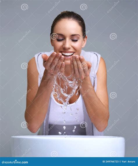 Aah So Refreshing An Attractive Young Woman Washing Her Face Stock