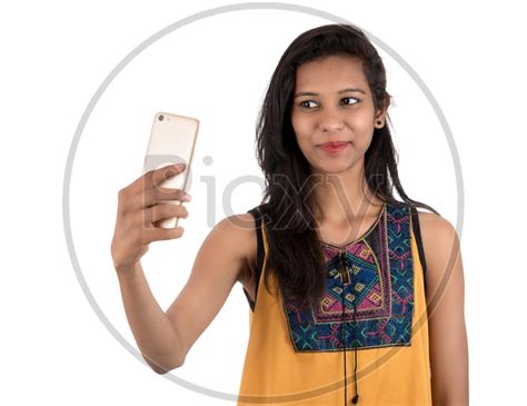 Image Of Young Indian Girl Taking Selfie With Mobile Or Smartphone On