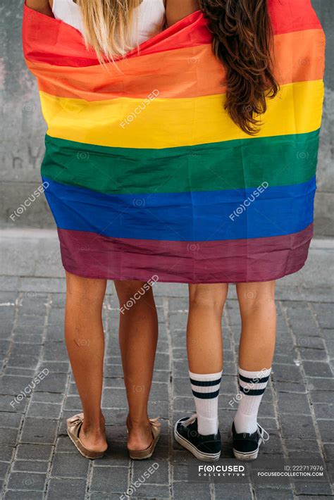 couple lesbian woman with gay pride flag on the street of madrid city — holidays homosexuals