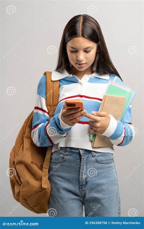 Interested Student Teen Girl With Backpack Looking At Smartphone Screen