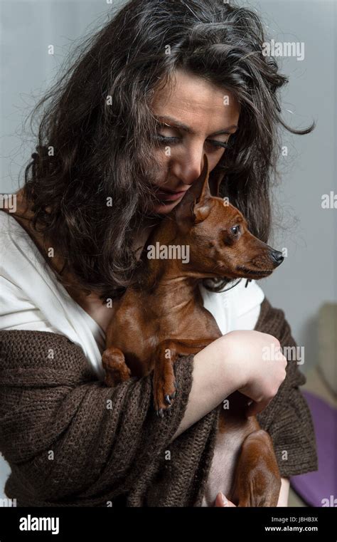 Woman Is Holding Her Dog Stock Photo Alamy