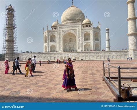 Indian Girl Standing In Front Of The Taaj Mahal Which Is Located In
