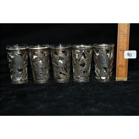 Five Decorated Sterling Silver Shot Glasses With Glass