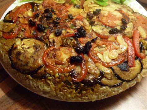 Maqluba or upside down recipe,a traditional arabic recipe cooked with rice,chicken or meat and fried vegetables like eggplant. Maqluba with Roast Pepper, Aubergine and Almond - beach ...