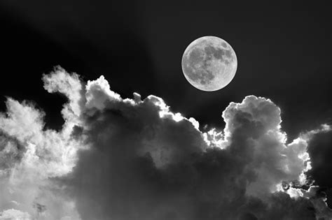 Full Moon In Night Sky With Dreamy Moonlit Clouds Stock Photo