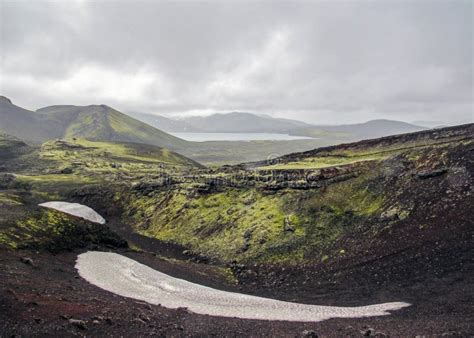 Green Moss Covered Volcanic Mountains And Blac Lava Field