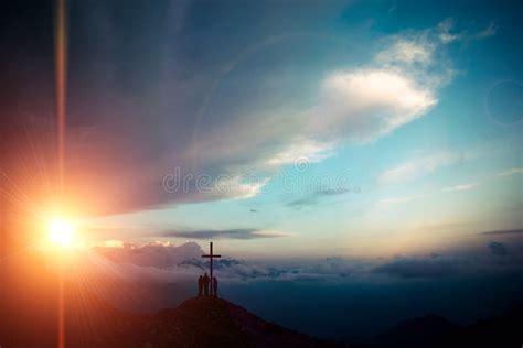 Cross At Sunset In Wild Mountains With Three People Stock Image Image