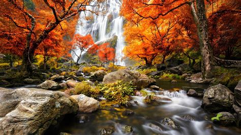 Waterfalls On Mountains And Waterstream Between Rocks Surrounded By Red