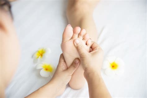 Free Photo Woman Receiving Foot Massage Service From Masseuse Close Up At Hand And Foot