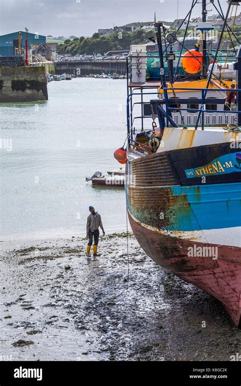 Padstow Harbour A Workman Checking The Hull Of The Fishing Trawler