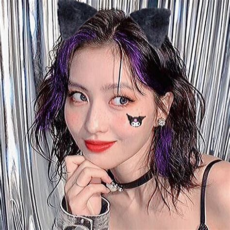 A Woman With Purple Hair And Black Cat Ears On Her Head Posing For A Photo