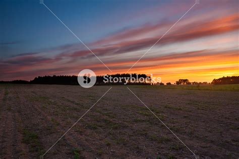 Beautiful Sky After Sunset Over Plowed Field In Springtime Royalty Free
