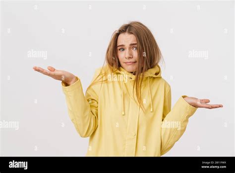 Photo Of Nice Brooding Woman In Raincoat Posing With Throwing Up Hands