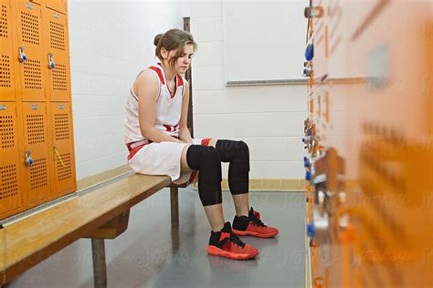 Female Basketball Player Sits Quietly On Bench In Locker Room Del