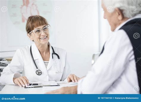 Doctor Smiling At Patient Stock Image Image Of Medical 107744153