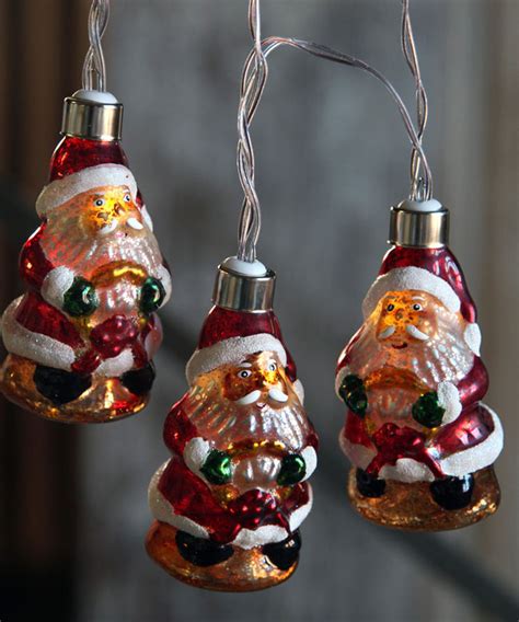 The pole is metal and is weighted. Battery Operated Antique Santa Glass String Lights - 10 Lights