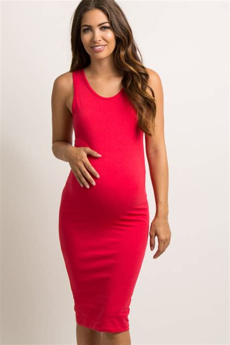 a solid hued fitted maternity dress featuring a rounded neckline and a sleeveless style