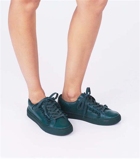 The frilly details give dresses and jeans a feminine edge. Tory Sport Women's Ruffle Leather Lace Up Sneakers in Blue ...