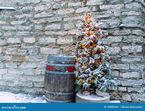 Brick Background With Decorated Snow Covered Christmas Tree Stock Image