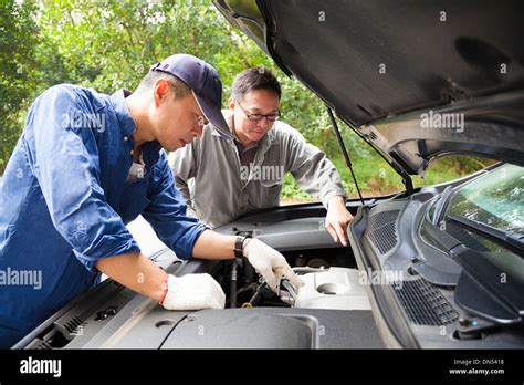 Two Mechanics Fixing The Car On The Road Stock Photo Alamy