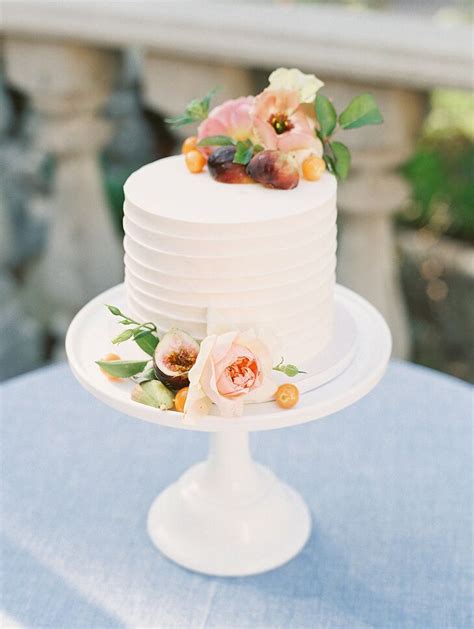 simple single tier wedding cake with fresh flowers