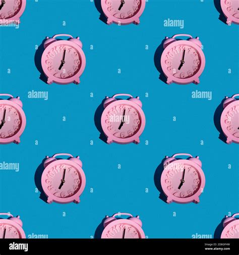Fashionable Pattern With A Pink Clock On A Blue Background Repeating