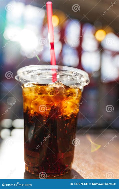 Close Up Shot Of Cold Refreshing Cola Drink With Ice And Bubbles In