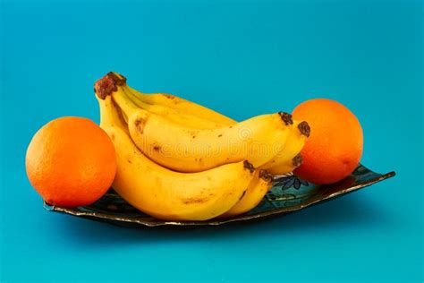 Fresh Bananas And Oranges On A Blue Dish Stock Photo Image Of Leaves