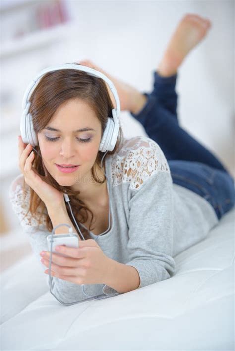 Young Beautiful Woman In Underwear Listening To Music Stock Photo
