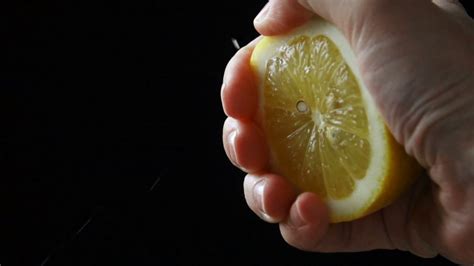 Slow Motion Squeeze Juice From Lemon Close Up Stock Footage Sbv