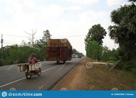 A Motorcycle Runs On National Highway 6 In Cambodia Loading Lots Of