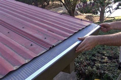 Spray polyurethane foam and coating to seal and facilitate drainage in valley gutter. Corrugated Metal Roof - Gutter Guard by Gutterglove®